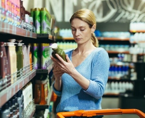 Femme qui choisi un produit cosmétique en rayon